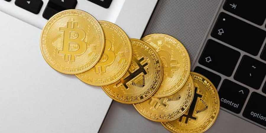 bitcoin coins on laptop keyboard